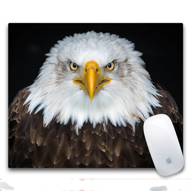 Custom printed rectangular mouse pad with cloth surface and rubber base on a desk.