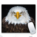 Custom printed rectangular mouse pad with cloth surface and rubber base on a desk.