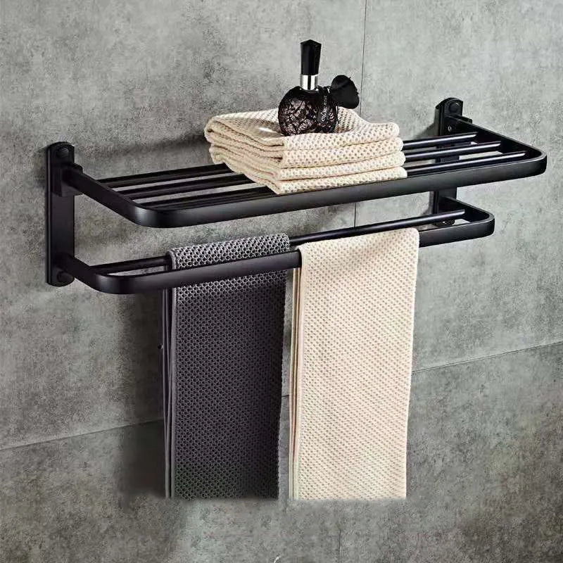 Aluminium double-layer folding bathroom shelf with hooks on a light-coloured wall.