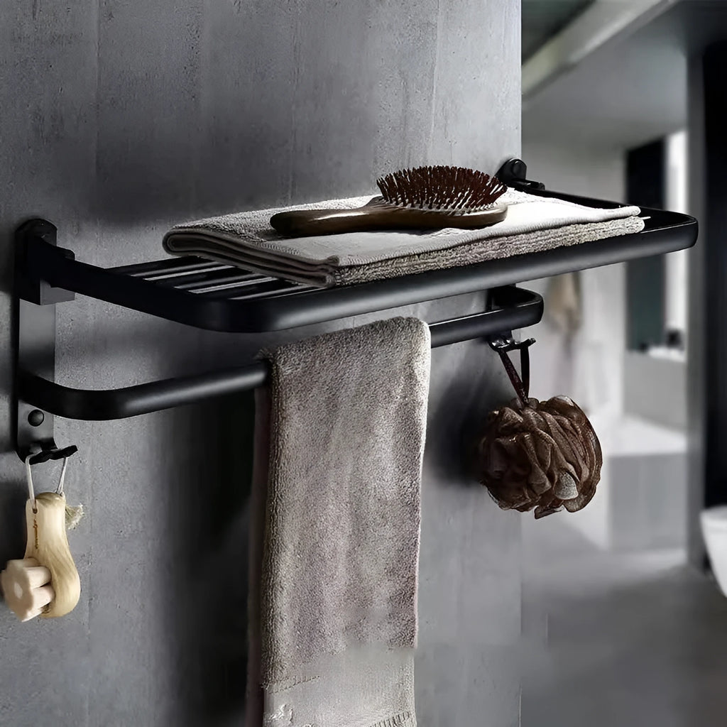 Aluminium double-layer folding bathroom shelf with hooks on a light-coloured wall.