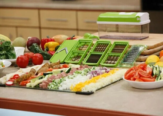 Green manual vegetable chopper with stainless steel blades and handheld design for kitchen food preparation