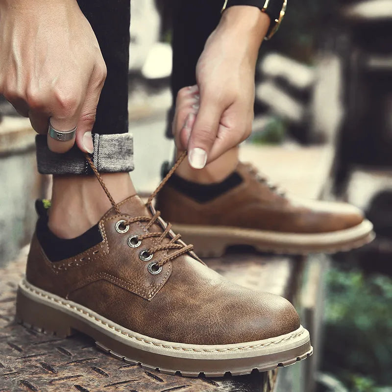Men's black casual lace-up shoes with round toe, flat heel, and rubber sole on a white background.