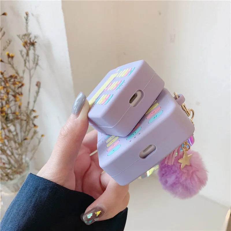 Purple silicone protective case for Apple AirPods with attached fur ball pendant