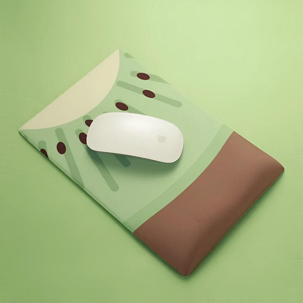 Cute kiwi fruit design mouse pad with a built-in thick grey wrist support cushion on a desk.