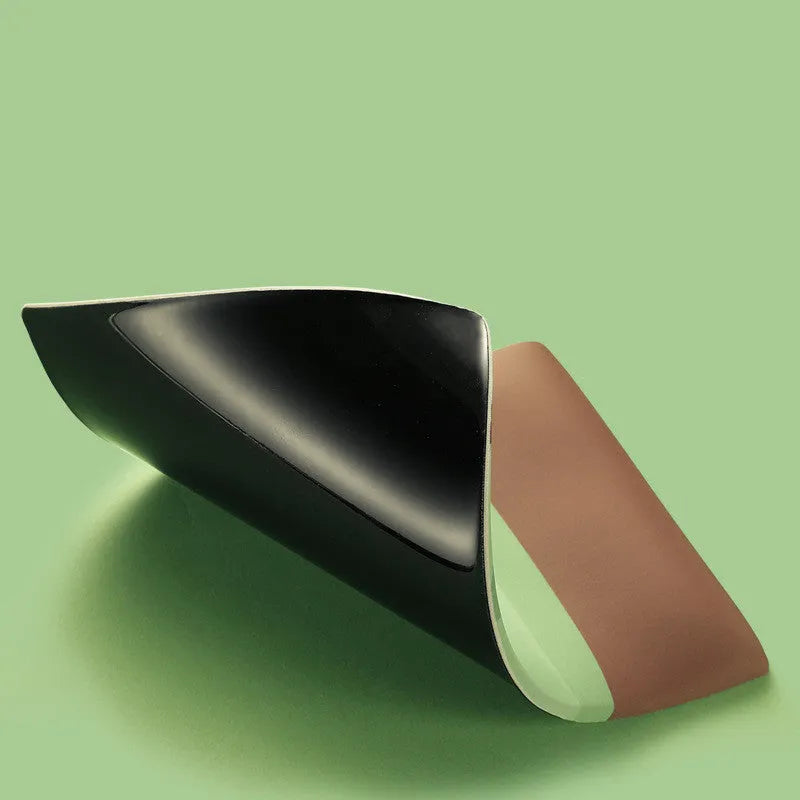 Cute kiwi fruit design mouse pad with a built-in thick grey wrist support cushion on a desk.