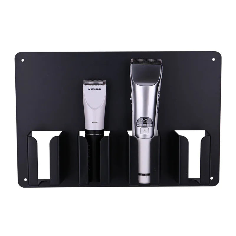 Black plastic wall-mounted frame holding four electric hair clippers