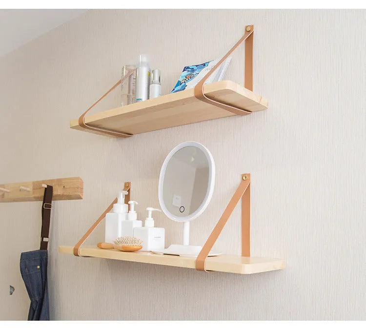 Nordic style pine wall mounted bookshelf measuring 50x16cm holding books and decor