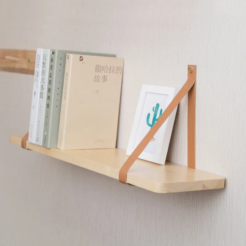 Nordic style pine wall mounted bookshelf measuring 50x16cm holding books and decor
