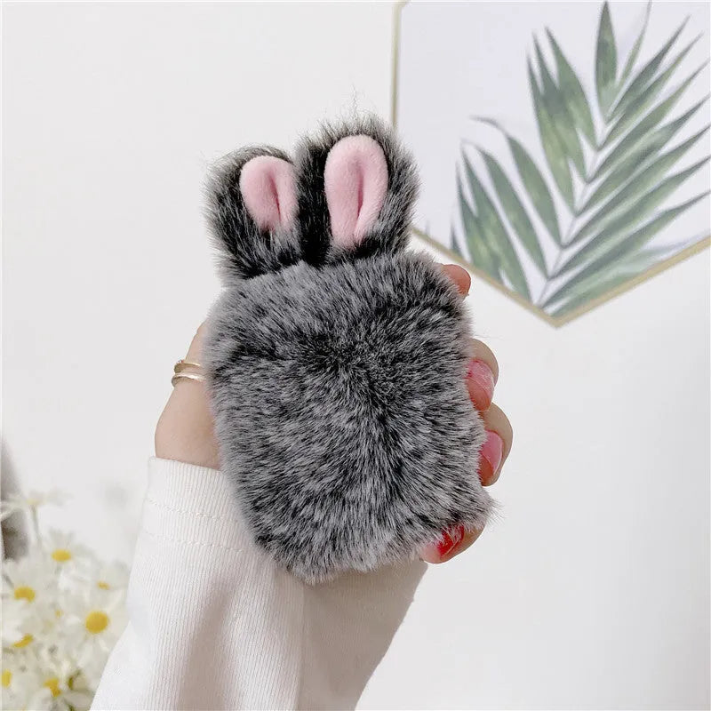 Pink rabbit ear silicone protective cover on Apple AirPods charging case