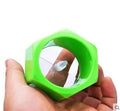 Yellow and green plastic vegetable spiral slicer for cucumbers on a kitchen counter.