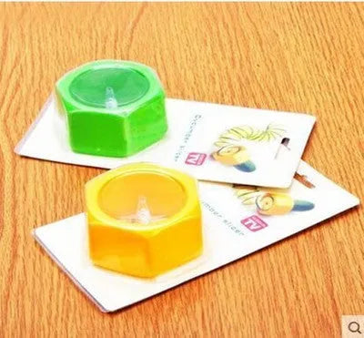 Yellow and green plastic vegetable spiral slicer for cucumbers on a kitchen counter.