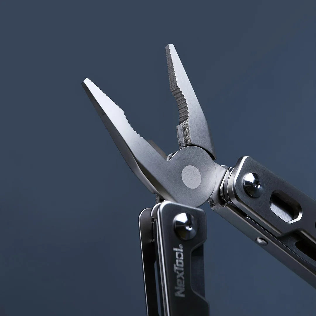 White stainless steel multi-function tool showing wrench, knife blade, and needle nose pliers jaws