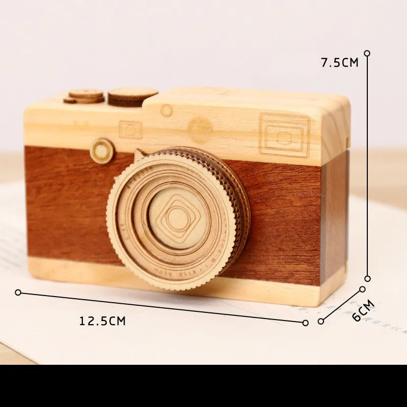 Wooden rotating camera music box in a miniature carton gift box.