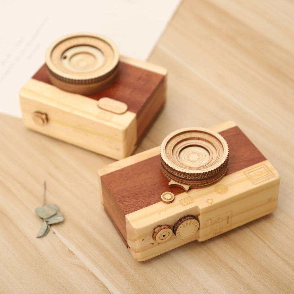 Wooden rotating camera music box in a miniature carton gift box.