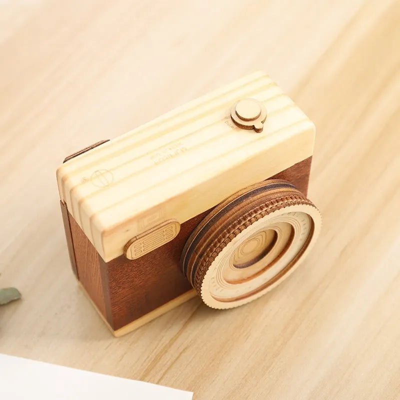 Wooden rotating camera music box in a miniature carton gift box.