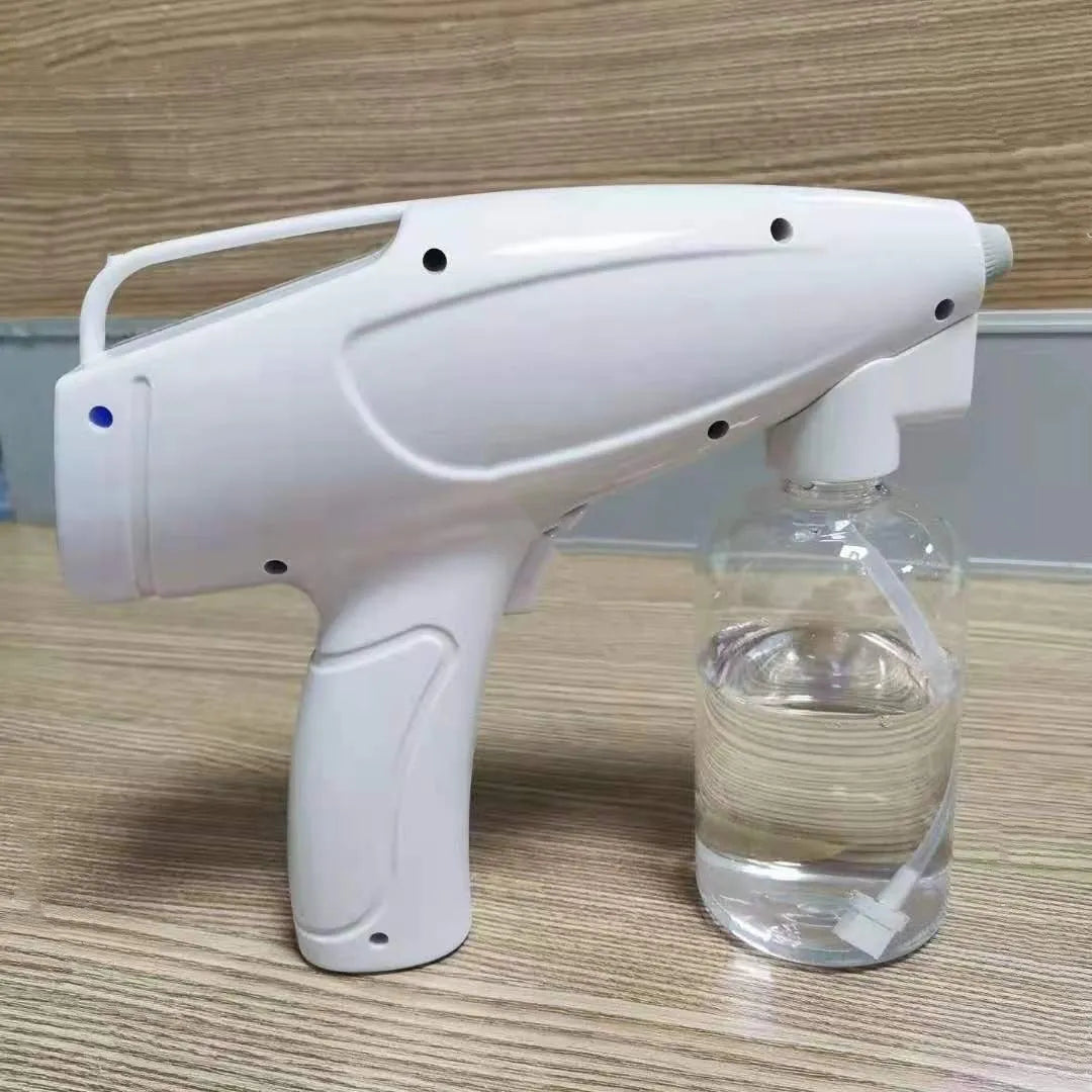 White cordless electric handheld spray disinfection gun with USB charging cable