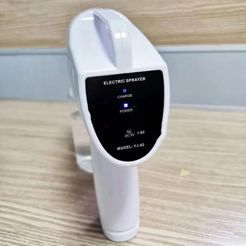 White cordless electric handheld spray disinfection gun with USB charging cable