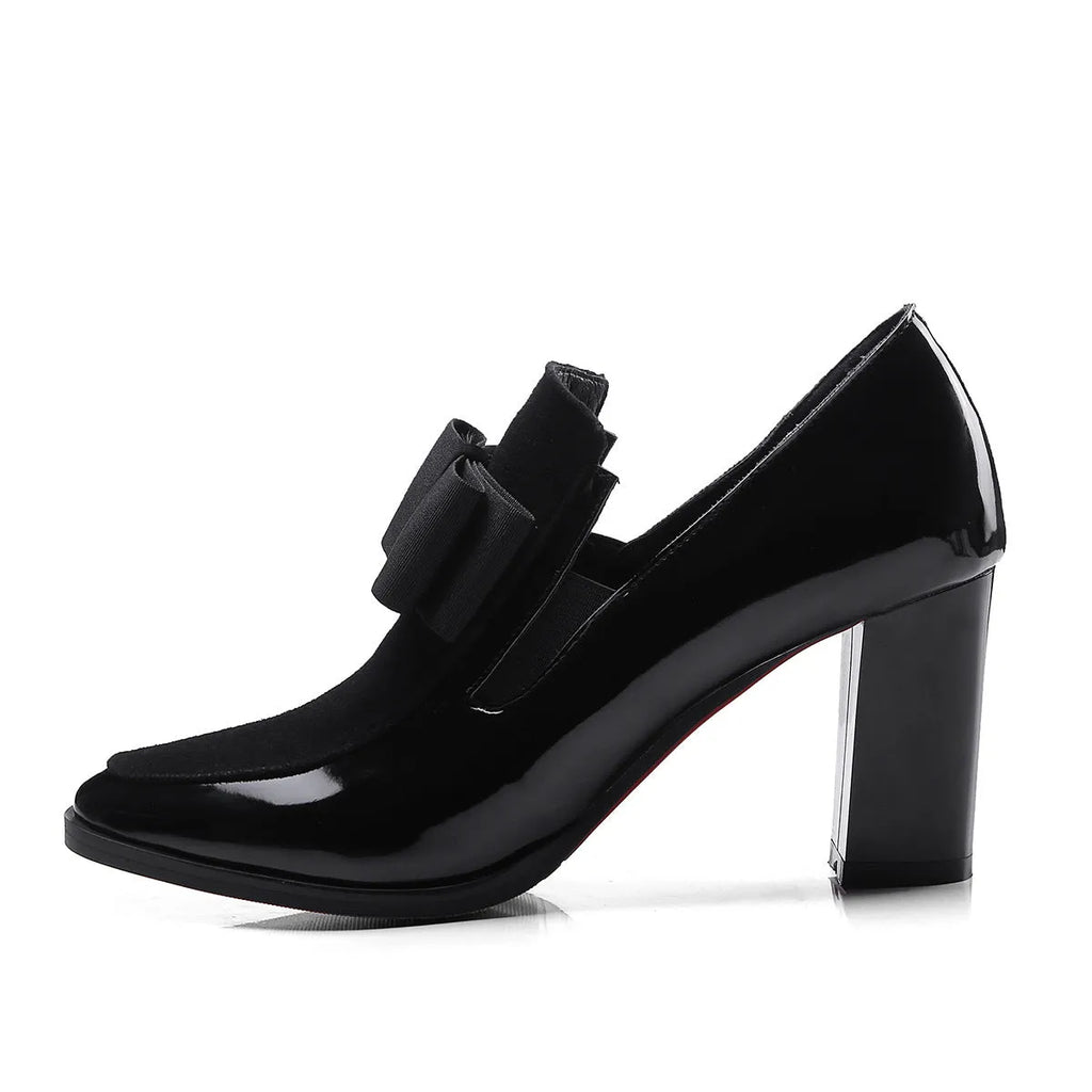 Women's black patent leather high heel shoes with a thick block heel and square toe, shown in a large size.