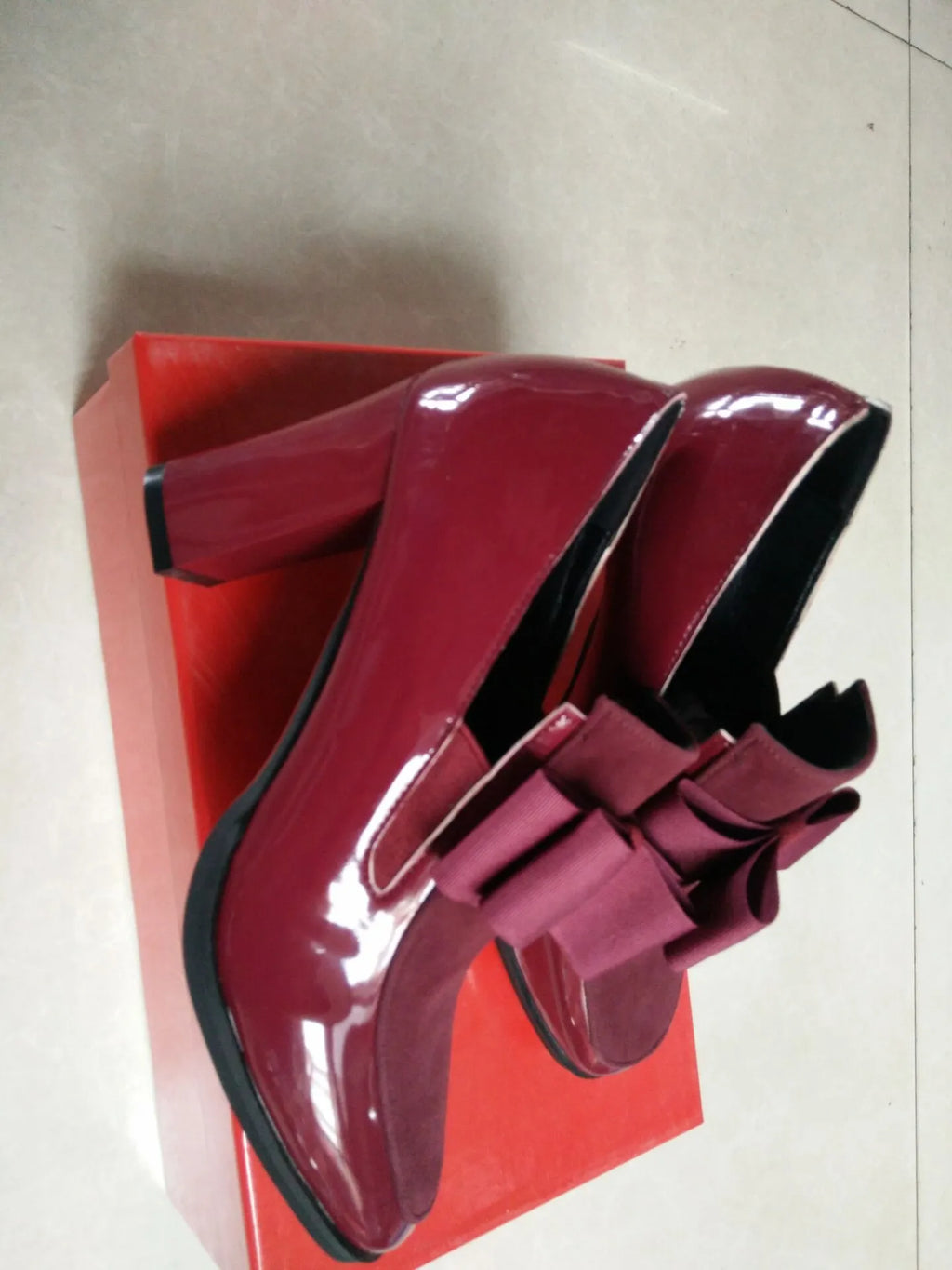 Women's black patent leather high heel shoes with a thick block heel and square toe, shown in a large size.