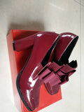 Women's black patent leather high heel shoes with a thick block heel and square toe, shown in a large size.
