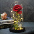 Silk rose bouquet LED ornament with glass cover and warm white lighting on wood base