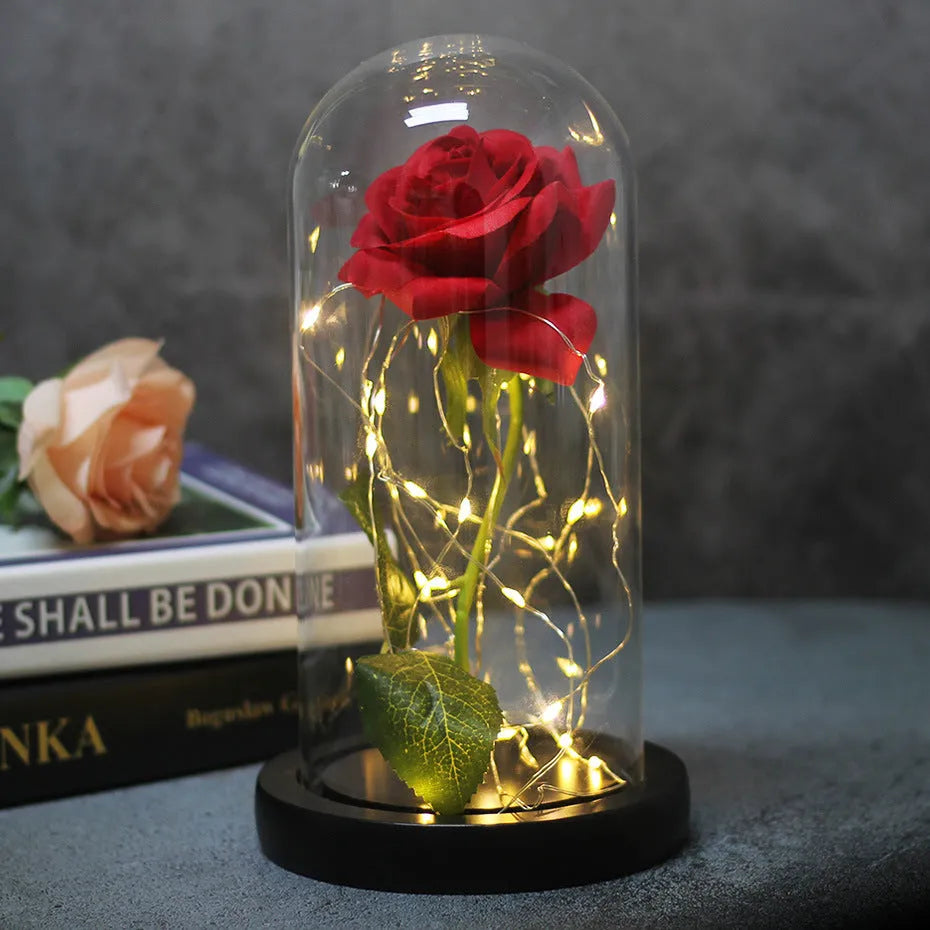 Silk rose bouquet LED ornament with glass cover and warm white lighting on wood base