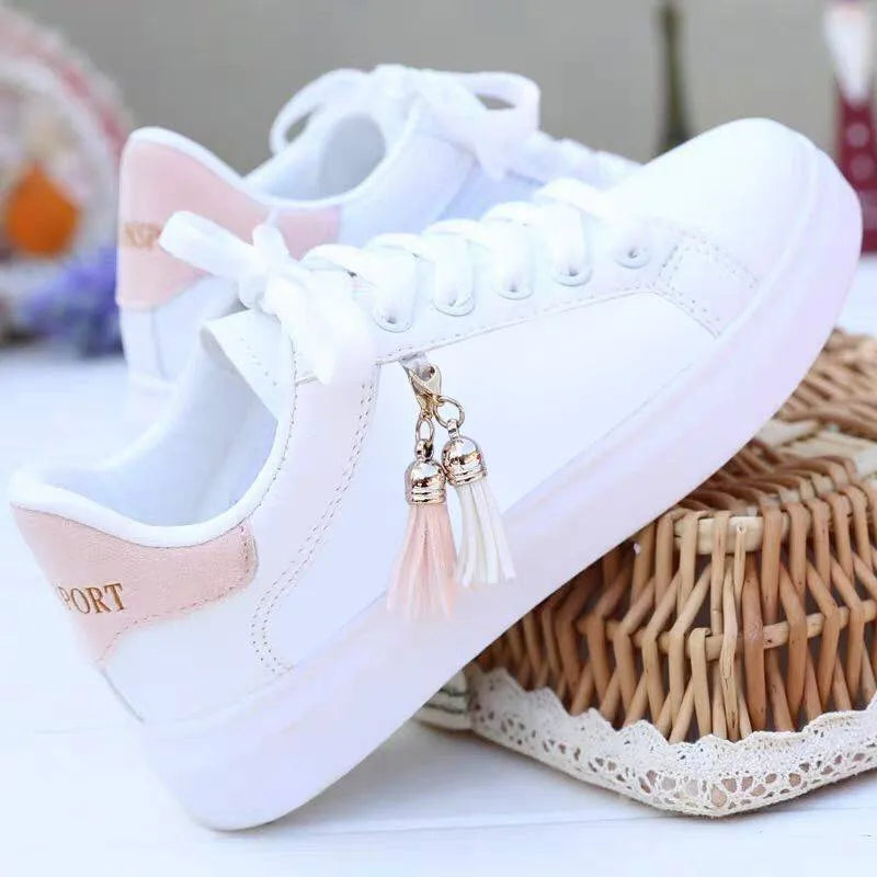 White mesh women's casual trainers with rubber sole on a pink background