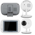 White UFO-shaped wireless baby monitor and camera on a nursery shelf.