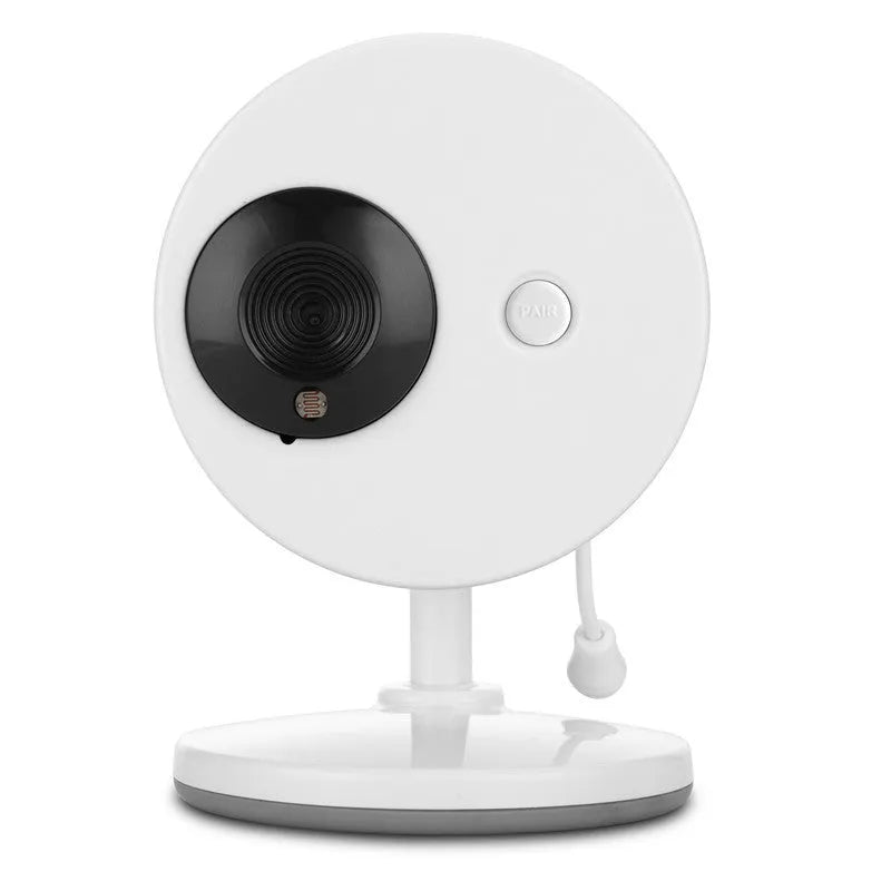 White UFO-shaped wireless baby monitor and camera on a nursery shelf.