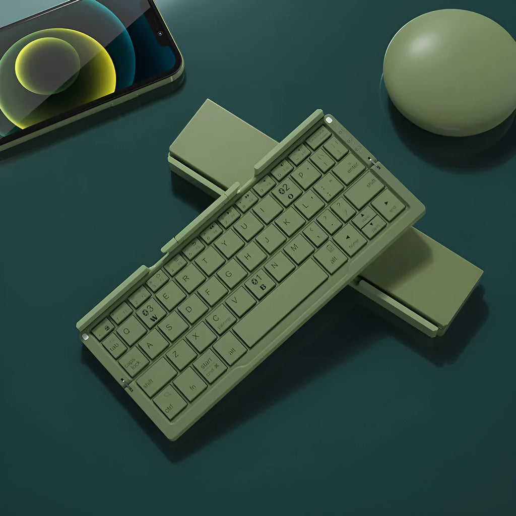 Silver folding Bluetooth keyboard open with tablet on stand, showing compact size and 60-key layout