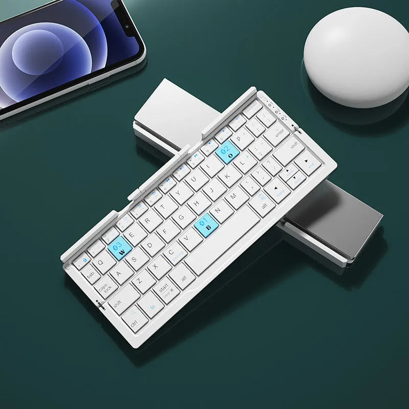 Silver folding Bluetooth keyboard open with tablet on stand, showing compact size and 60-key layout