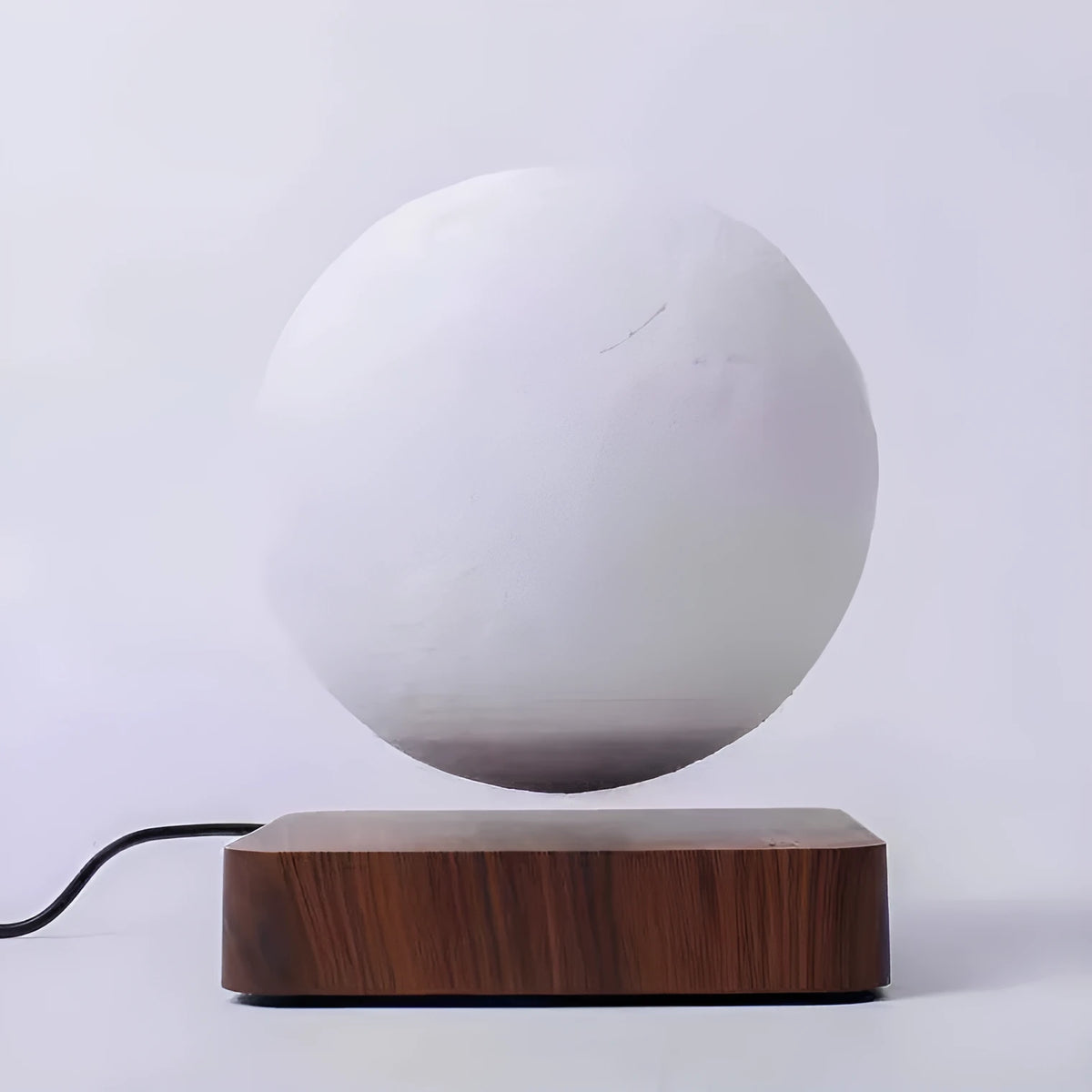 Magnetic levitation 3D moon night light, 14cm diameter, floating above a wooden base with touch switch.