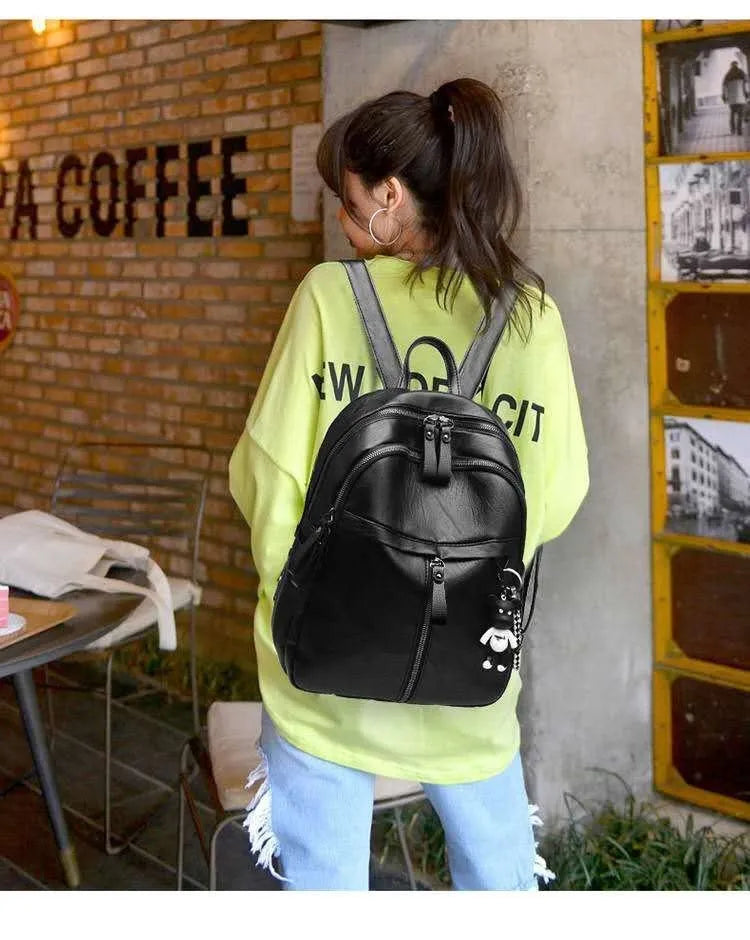 Black medium-sized PU leather backpack with double straps, shown with a 24cm dimension.