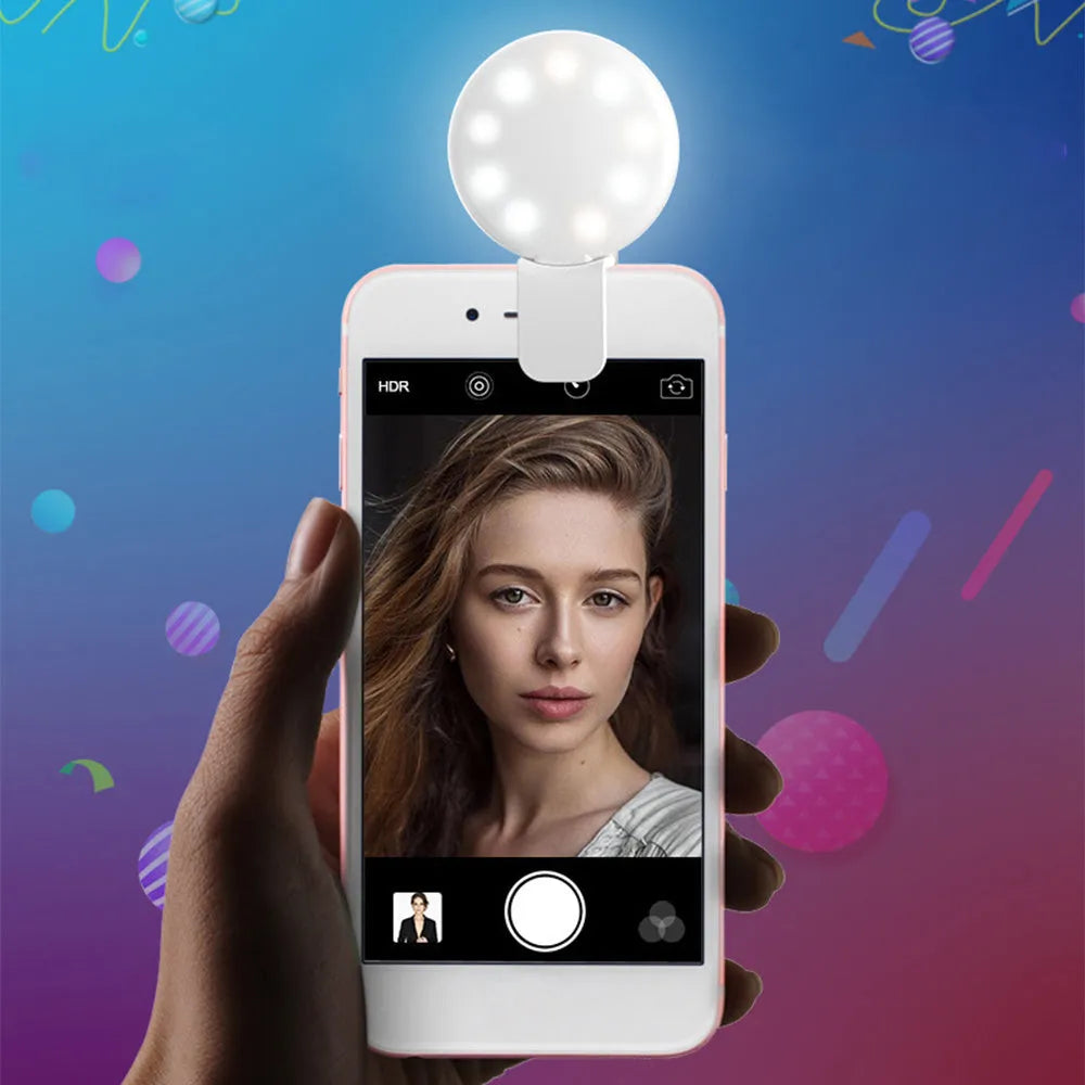 Mini clip-on LED fill light attached to mobile phone for selfie photography