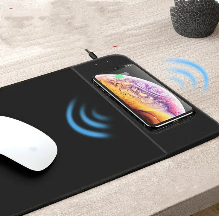 Cartoon design wireless charging mouse pad with RGB lighting, showing cloth surface and USB cable.
