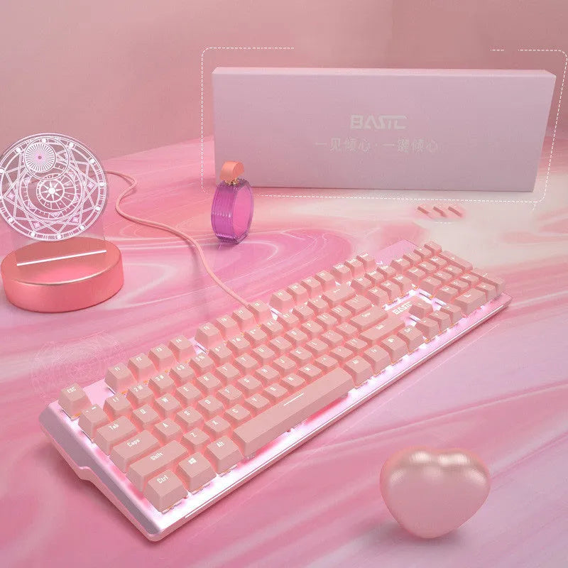 Pink wired mechanical keyboard and matching mouse set on a desktop.