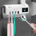 Black intelligent UV toothbrush steriliser with automatic toothpaste squeezer mounted on bathroom wall