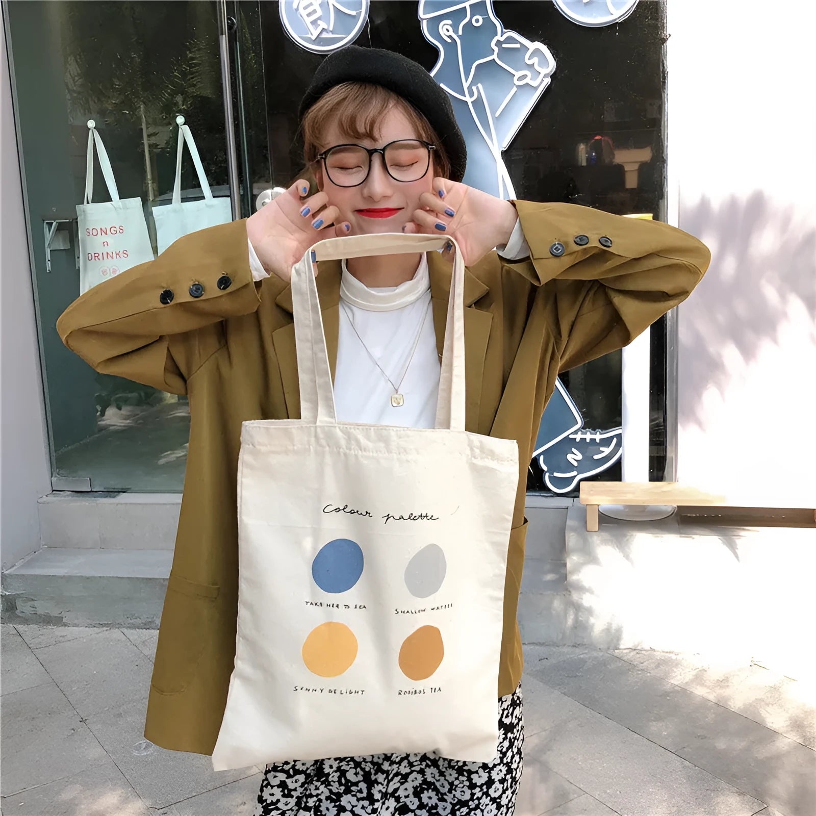 Medium geometric print canvas tote bag with soft handles, shown in light pink and orange colour options.