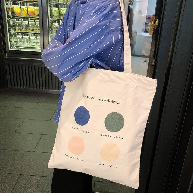 Medium geometric print canvas tote bag with soft handles, shown in light pink and orange colour options.