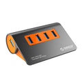 Dark grey aluminium USB hub with orange accents and separate cable showing four USB 3.1 ports