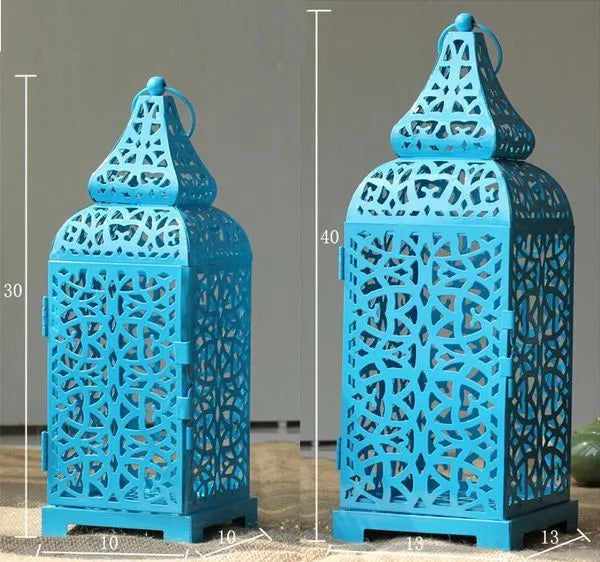 Blue geometric iron Moroccan lantern candlestick on a table.