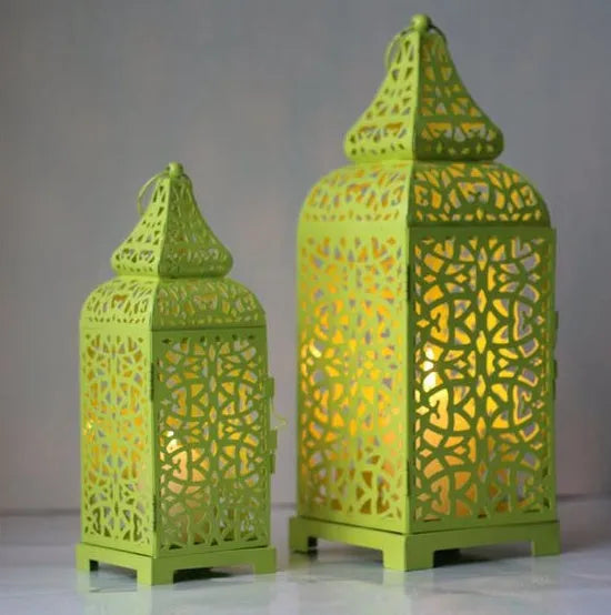 Blue geometric iron Moroccan lantern candlestick on a table.