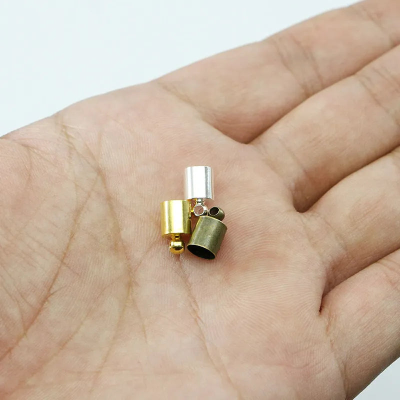 Assorted copper weight caps in different sizes and metallic colours for jewellery making.