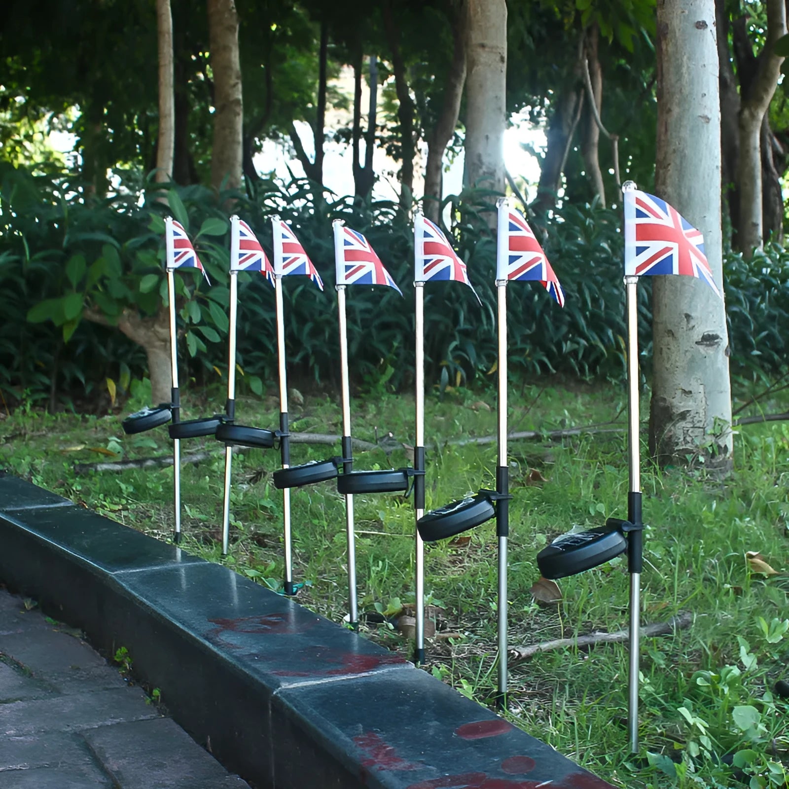 Solar-powered garden flag light with stainless steel pole displaying American or British flag design