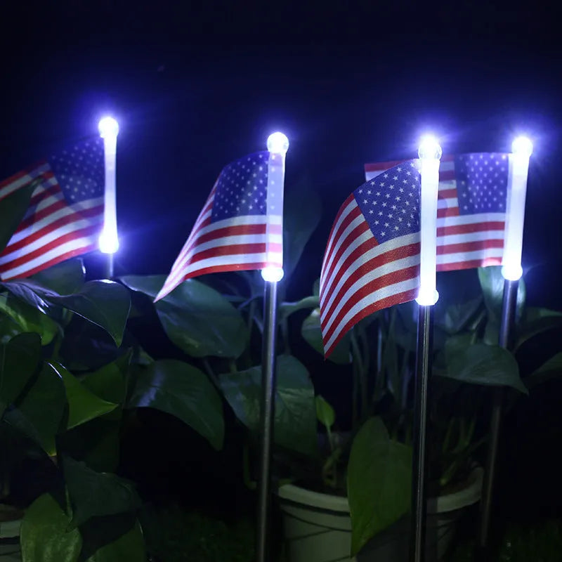 Solar-powered garden flag light with stainless steel pole displaying American or British flag design