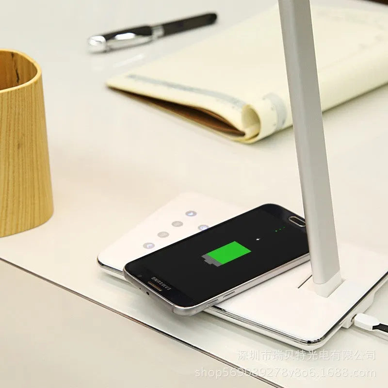 Black and white wireless charging desk lamp with touch controls and USB power connection