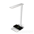 Black and white wireless charging desk lamp with touch controls and USB power connection