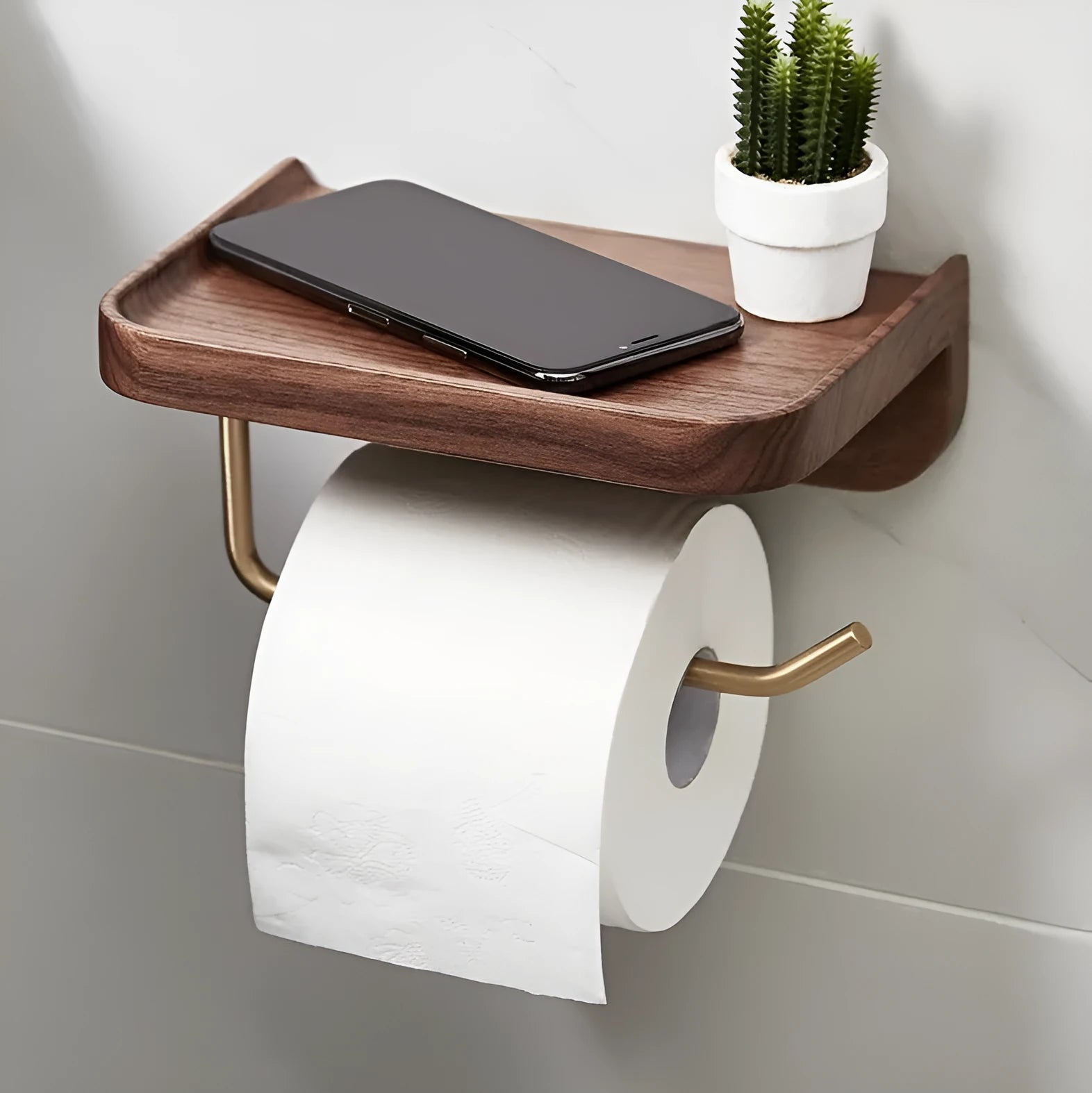 Solid walnut wood and brass wall-mounted paper towel and toilet roll holder on a wall.