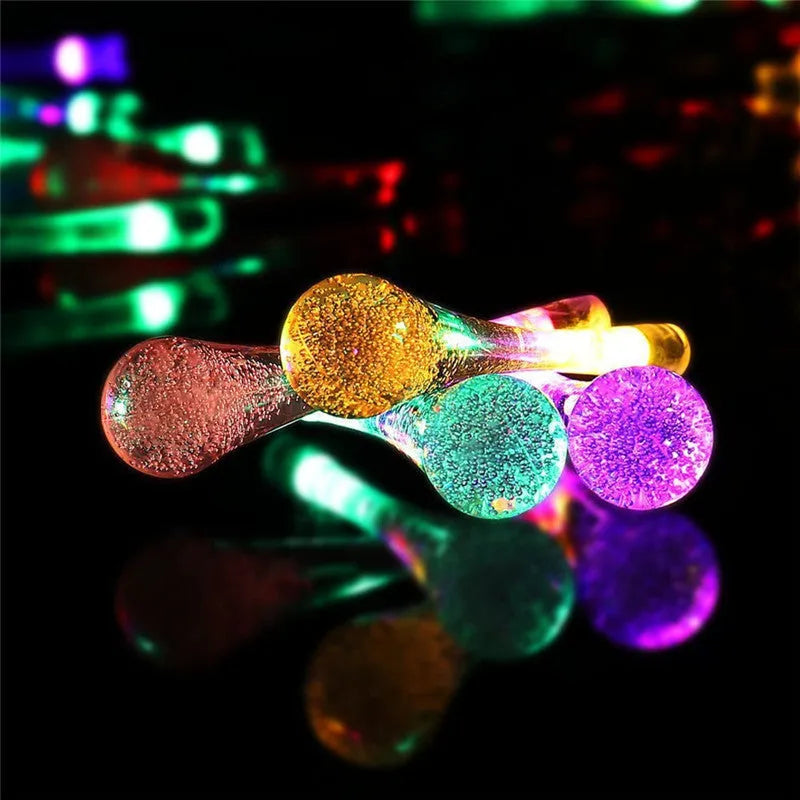 Solar-powered LED garden string lights with water drop shaped ABS pendants on a 6.5 metre wire.
