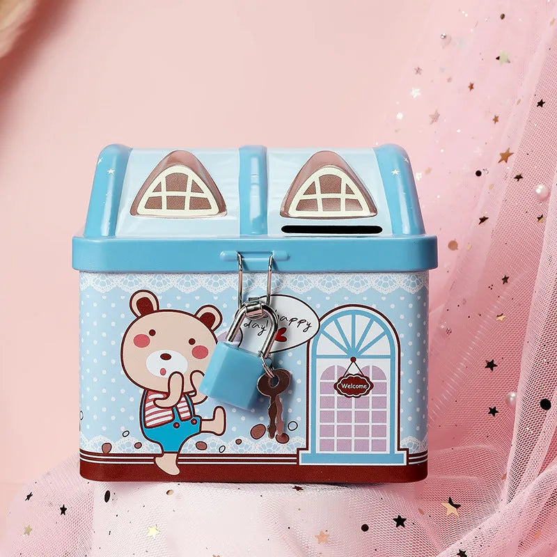 Blue house shaped tinplate piggy bank for coin storage on desktop